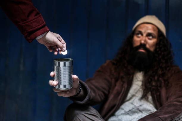 istock Giving change to a beggar 1452170517
