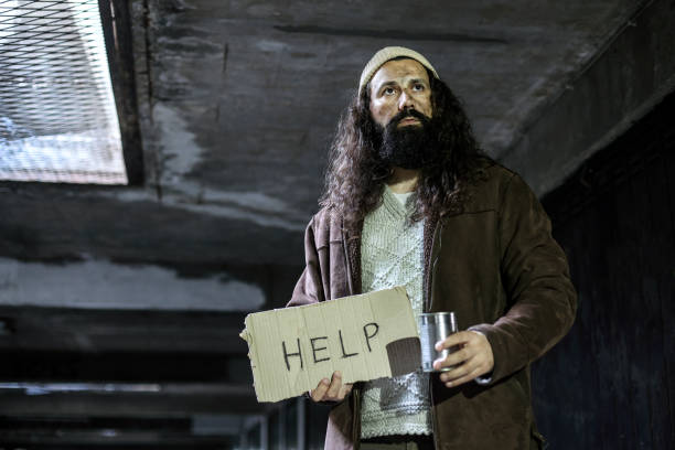 Homeless man on begging on the street. About 45 years old, Caucasian male.