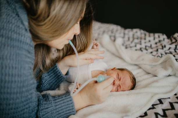 istock Mother using nasal aspirator for her son 1452172888