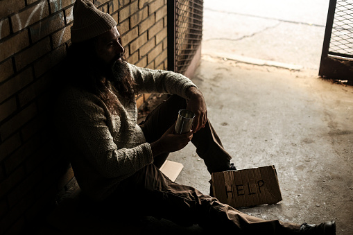 Homeless man on begging on the street. About 45 years old, Caucasian male.