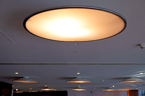 Large-area ceiling light with a space design, circular and oval, black stripe.