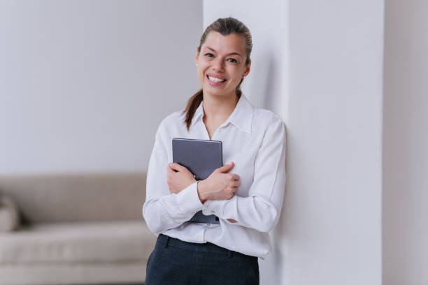 istock Professional young develop specialist woman standing at office holding tablet smiling wide looks at camera happily. Successful manager completed all tasks. Happy student hispanic girl passed exam. 1452194081