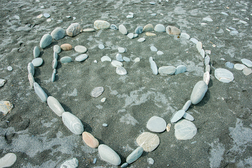 Heart of stone, shape of arranged smooth beach stones