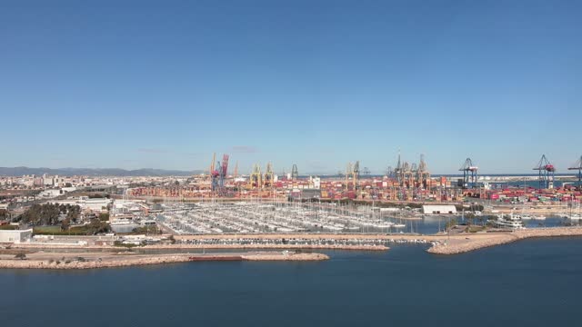 Large cranes and containers in seaport of Valencia. Aerial view of port Valencia