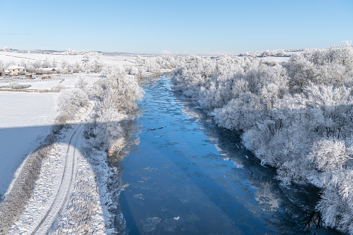 Snow and ice around he River Teviot from Roxburgh Viaduct in the Scottish Borders