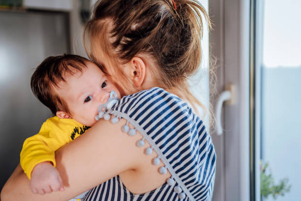istock Mother with baby in arms 1452205880