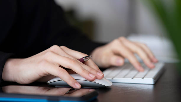 istock Female office worker typing on the keyboard 1452210217