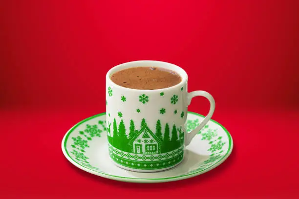 Turkish coffee in a christmas themed cup on red background