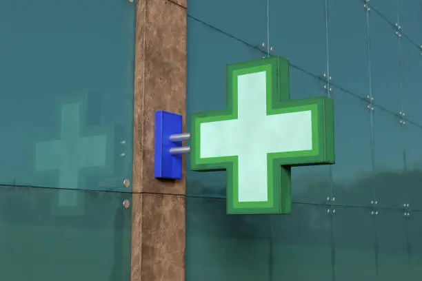 Photo of Generic green cross sign of a pharmacy. Illustration of the concept of drug stores, prescriptions and health.