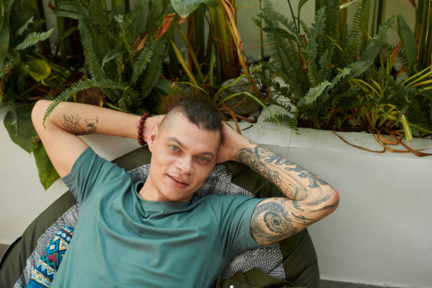 istock Young Man Relaxing in Armchair 1452221913