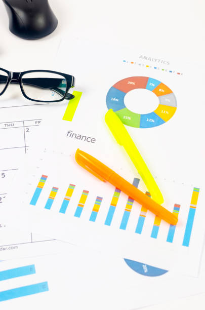 istock Working set for analyzing statistics and results of last year. Charts and graph with financial data, laptop, glasses. 1452224680