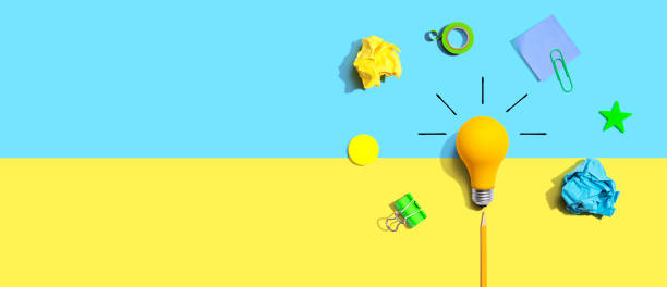 istock Brainstorming concept with a light bulb and school supplies - Flat lay 1452228355