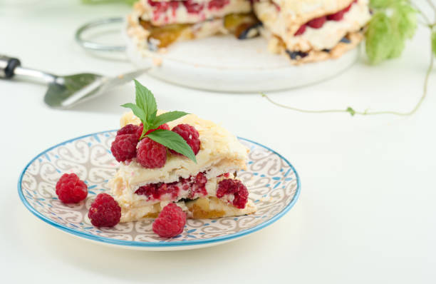 istock Round meringue pie with fresh raspberries on a white background, Pavlova dessert 1452230213