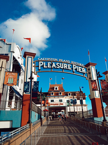 Historic pier in Galveston, Texas, United States. There is 1 roller coaster, 15 rides, carnival games and souvenir shops.