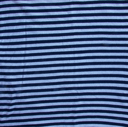 Nautical textile texture for background. Close up of a marine textile texture with blue and white stripes.