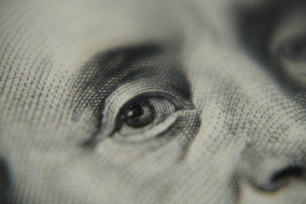 istock Close up shot of Benjamin Franklin's face on a hundred dollar banknote. 1452232625