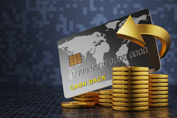 A stack of coins in front of a bank card. Money back concept. Cash back. The arrows are spinning around the debit card on the inscription cashback. 3D visualization stock photo