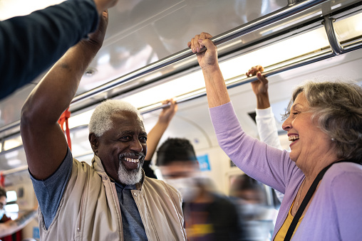 Senior friends talking in the subway train