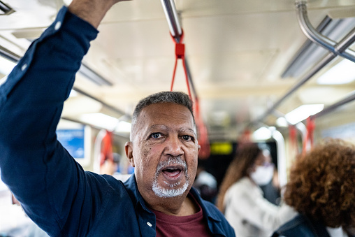 Senior man in a subway train