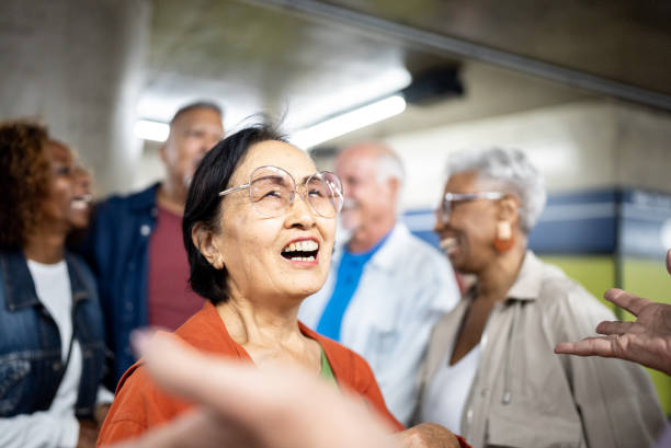 Senior woman talking with her friends in a subway station