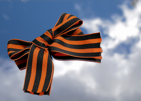9th May. The concept of the Great Victory Day of 1941-1945 and Defender of the Fatherland Day. St. George ribbon on a blue sky background.