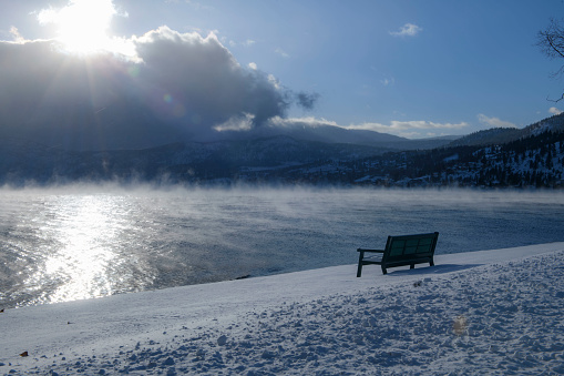 A bench on the shore in winter