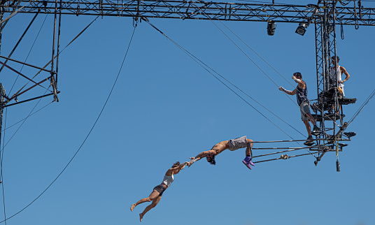 Sibiu City, Romania - 28 June 2022 trapeze artists acrobats from CirkVOST, on the metal scaffolding at the International Theatre Festival from Sibiu, Romania.