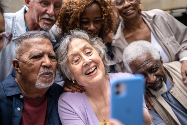 istock Senior friends taking a selfie or filming using mobile phone outdoors 1452236005