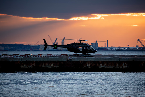 Helicopter at heliport during sunset