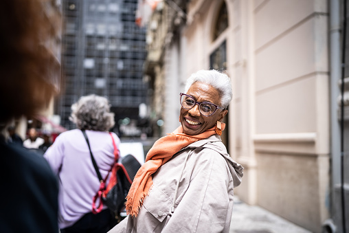 Portrait of a senior tourist woman walking outdoors