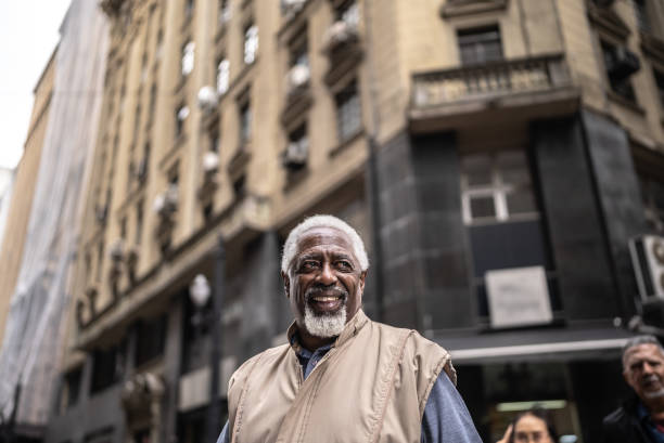 istock Senior man walking looking around at city 1452241728