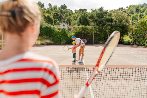 istock Playing tennis with mom and dad 1452243755