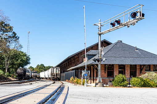 Carrollton, Georgia, USA-Oct. 20, 2022: The Carrollton Train Depot was build circa 1888 and played a key role in the development of the area's textile industry. It has been restored and is now known as the Old Depot on Bradley Street and is used as a banquet hall. The railroad tracks are still in use.