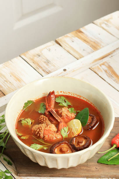 istock Tom Yum Gung with Prawn, Squid, and Mushroom. Served with Corriander and Lime 1452260278