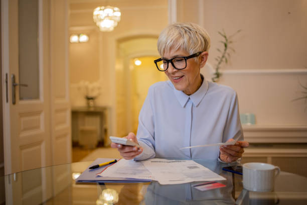 Senior woman going through paperwork stock photo