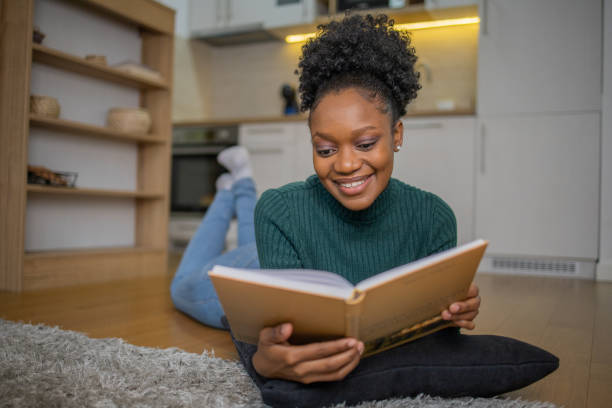 istock Woman relaxing and reading a book 1452262414