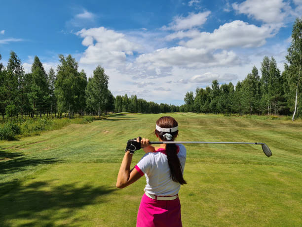 istock Woman holds golf club behind back closeup 1452264875