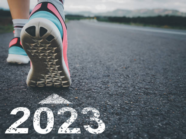 istock Young woman preparing to soar with 2023. Message on the road 1452268407