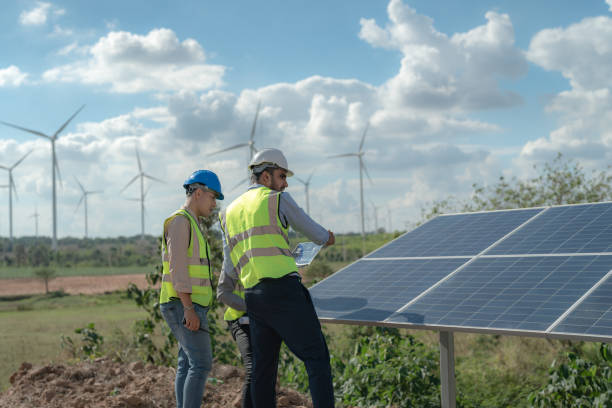 istock engineer man inspects construction of solar cell panel or photovoltaic cell by electronic device. Industrial Renewable energy of green power. factory worker working on tower roof. 1452277407