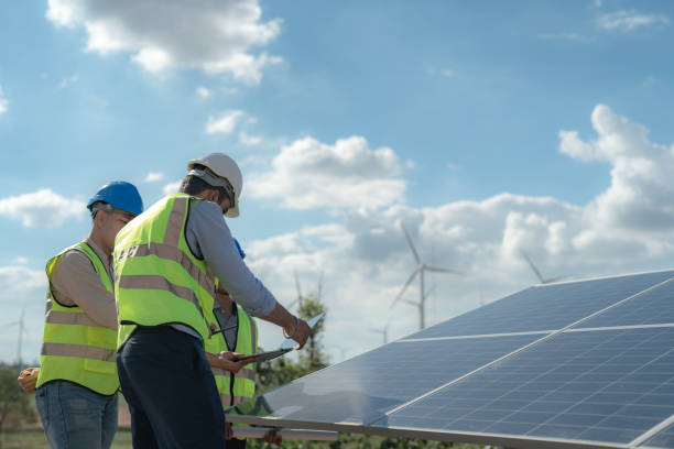istock engineer man inspects construction of solar cell panel or photovoltaic cell by electronic device. Industrial Renewable energy of green power. factory worker working on tower roof. 1452278851