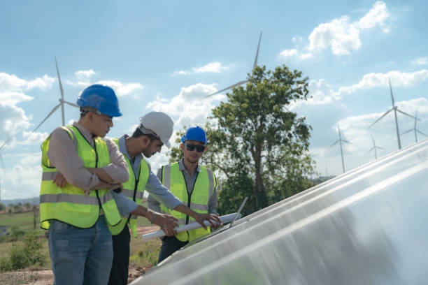 istock engineer man inspects construction of solar cell panel or photovoltaic cell by electronic device. Industrial Renewable energy of green power. factory worker working on tower roof. 1452278962