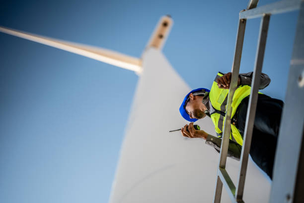 istock Asian engineers working in fieldwork outdoor. Workers check and inspect construction and machine around building project site. Wind turbine for electrical of clean energy and environment sustainable. 1452280297