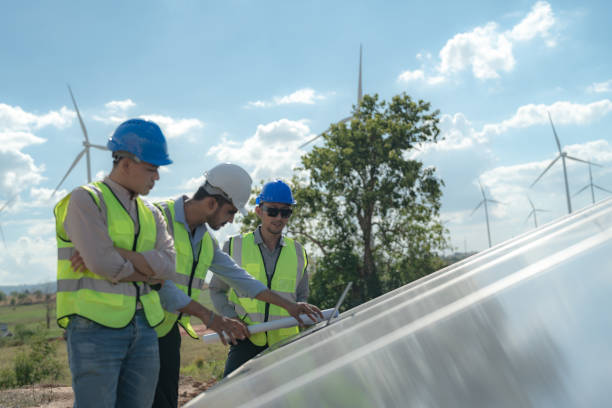 istock engineer man inspects construction of solar cell panel or photovoltaic cell by electronic device. Industrial Renewable energy of green power. factory worker working on tower roof. 1452280357