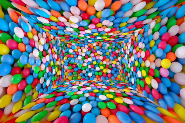 Multi colored, highly saturated plastic balls, in soft play ball pit, at a child's play park. Colorful balloon room background texture.