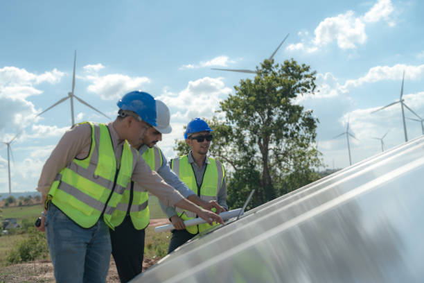 istock engineer man inspects construction of solar cell panel or photovoltaic cell by electronic device. Industrial Renewable energy of green power. factory worker working on tower roof. 1452288725