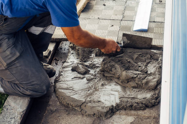 istock Bricklayer lays tiles. Professional builder in overalls and baseball cap at work. Elderly mason working outside. Close-up. 1452293768