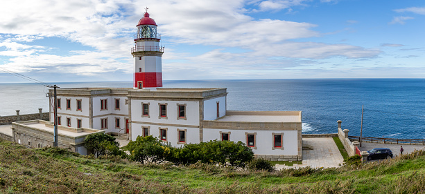 Baiona, Spain - December 05, 2022: maritime lighthouse in the atlantic ocean called faro silleiro, tourist place, in the town of Baiona, Spain