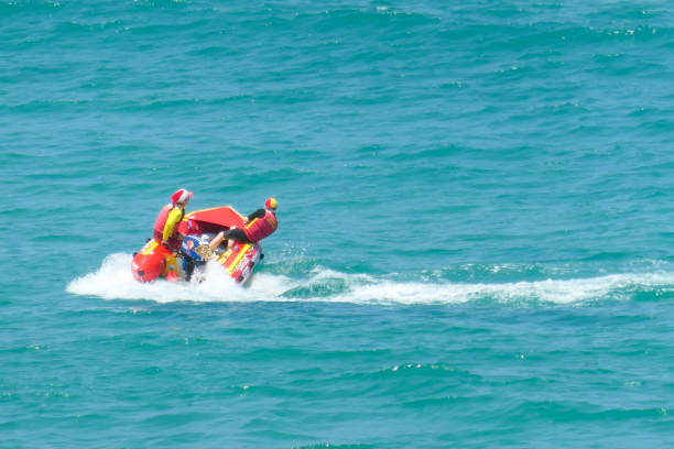 Volunteer lifesavers of Surf Life Saving NSW execute a turn during their patrol in an inflatable boat off Bondi Beach, Sydney on Christmas Day 2022.  This image was taken on a sunny afternoon from the cliffs on the southern end of the beach.