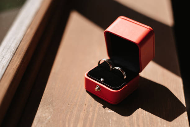 istock pair of gold wedding rings in a red box 1452302838