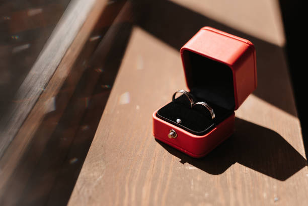 istock pair of gold wedding rings in a red box 1452302872